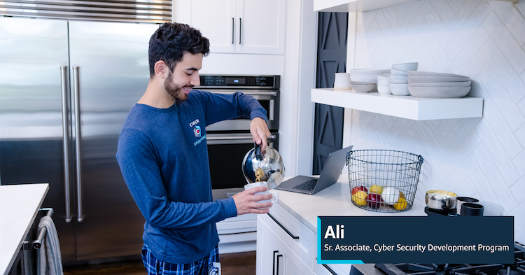 Ali, Capital One Senior Associate, Cyber Security Development Program, stands in his kitchen and pours tea